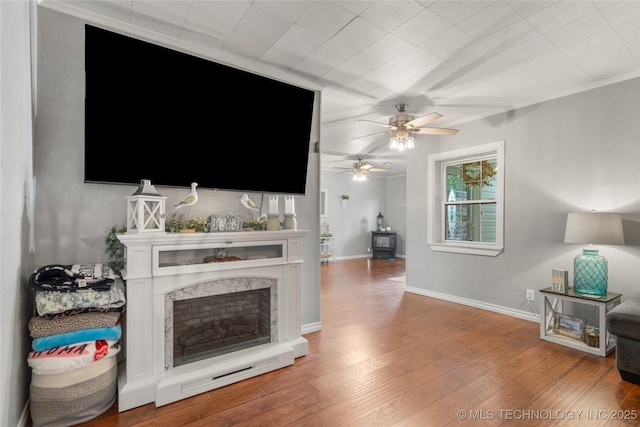 1732 N Little, Cushing, OK 74023 - living room with ceiling fan, a fireplace, and wood finished floors