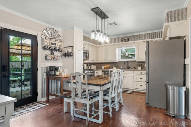 1732 N Little, Cushing, OK 74023 - dining area with dark wood-style floors and ornamental molding