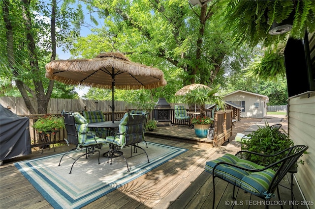 1732 N Little, Cushing, OK 74023 - wooden terrace with outdoor dining space and an outdoor structure