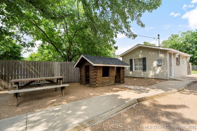 1732 N Little, Cushing, OK 74023 - view of front of property featuring log siding and an outbuilding