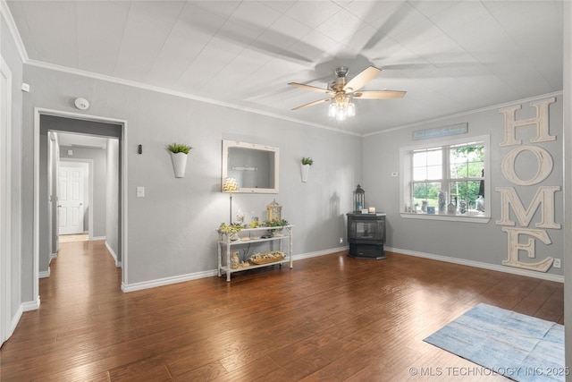 1732 N Little, Cushing, OK 74023 - interior space with a wood stove, ceiling fan, wood finished floors, and crown molding
