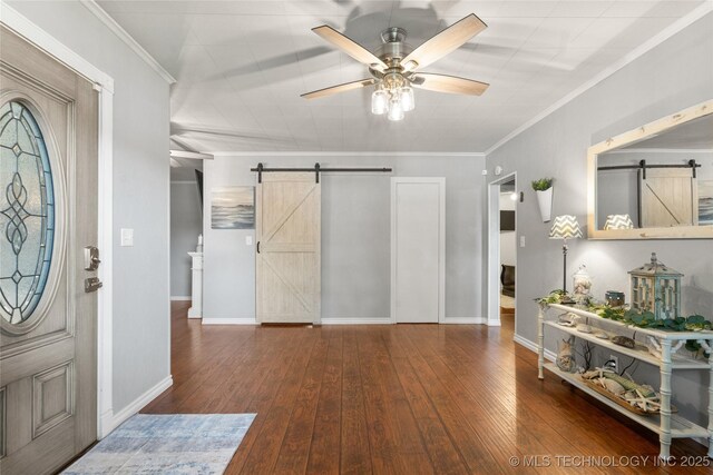 1732 N Little, Cushing, OK 74023 - foyer entrance featuring a barn door, a ceiling fan, ornamental molding, and hardwood / wood-style flooring