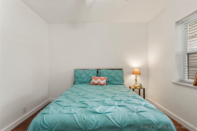 1732 N Little, Cushing, OK 74023 - bedroom with multiple windows, wood finished floors, and ceiling fan