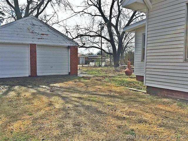 403 W Broadway, Marietta, OK 73448 - view of yard with an outdoor structure and a garage