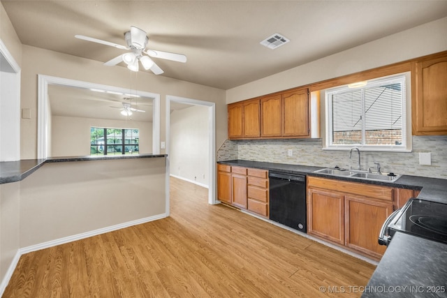 9429 E 36th St, Tulsa, OK 74145 - kitchen with black appliances, a sink, light wood-type flooring, and brown cabinets