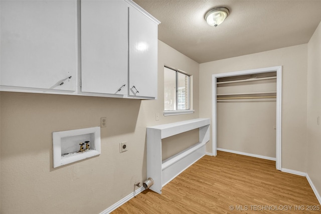 9429 E 36th St, Tulsa, OK 74145 - laundry area with electric dryer hookup, hookup for a washing machine, cabinet space, light wood finished floors, and baseboards