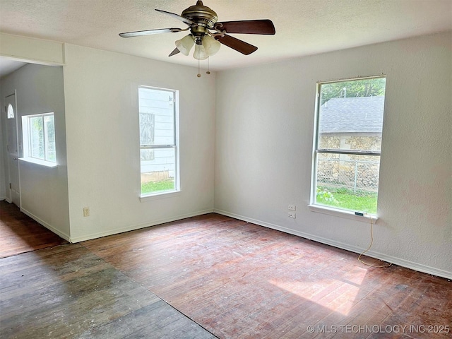 419 Minor St, Tahlequah, OK 74464 - spare room featuring healthy amount of natural light, wood finished floors, ceiling fan, and a textured ceiling