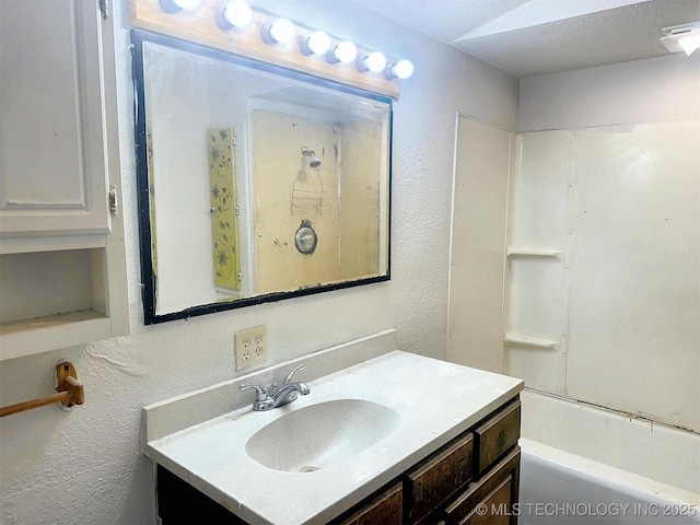 419 Minor St, Tahlequah, OK 74464 - full bath with vanity, a textured wall, and shower / washtub combination