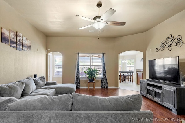 20225 E 44th St S, Broken Arrow, OK 74014 - living room featuring arched walkways, a ceiling fan, and dark wood-type flooring
