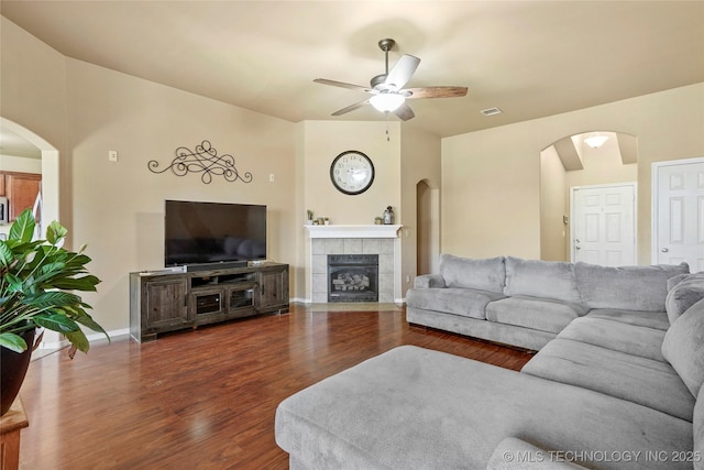 20225 E 44th St S, Broken Arrow, OK 74014 - living room with arched walkways, ceiling fan, wood finished floors, a tile fireplace, and baseboards