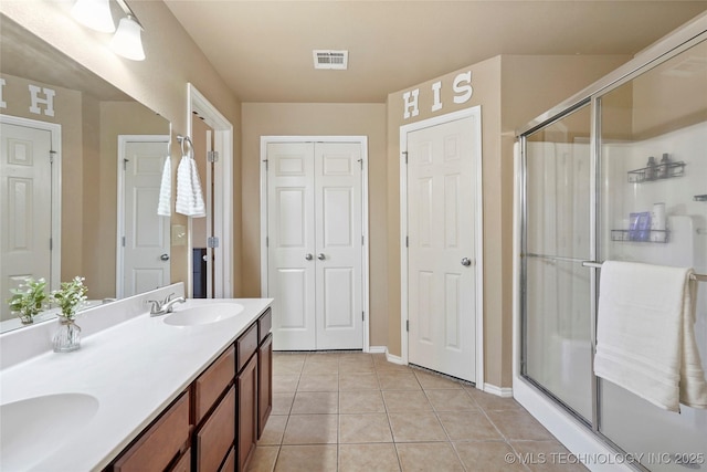 20225 E 44th St S, Broken Arrow, OK 74014 - full bathroom with double vanity, tile patterned floors, a stall shower, and baseboards