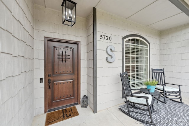 5720 E 144th St N, Collinsville, OK 74021 - doorway to property featuring covered porch