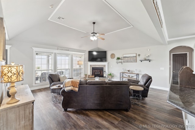 5720 E 144th St N, Collinsville, OK 74021 - living room featuring vaulted ceiling, ceiling fan, dark wood-style flooring, a fireplace, and arched walkways
