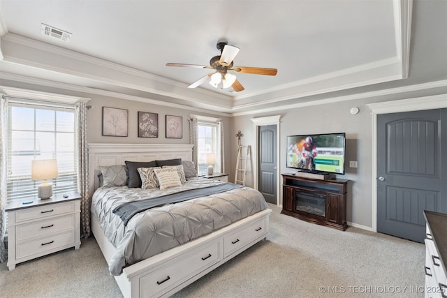 5720 E 144th St N, Collinsville, OK 74021 - bedroom featuring a tray ceiling, ornamental molding, light colored carpet, and a ceiling fan