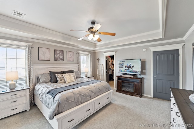 5720 E 144th St N, Collinsville, OK 74021 - bedroom with a tray ceiling, light colored carpet, a spacious closet, crown molding, and a closet