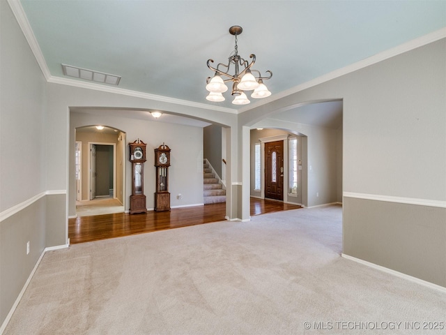 4708 W Indianola St, Broken Arrow, OK 74012 - empty room featuring arched walkways, carpet, a chandelier, stairs, and crown molding