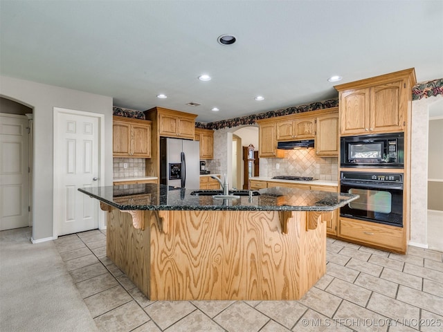 4708 W Indianola St, Broken Arrow, OK 74012 - kitchen with black appliances, arched walkways, a sink, under cabinet range hood, and recessed lighting