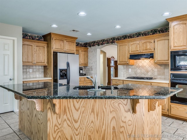 4708 W Indianola St, Broken Arrow, OK 74012 - kitchen featuring black appliances, a sink, under cabinet range hood, arched walkways, and light tile patterned floors
