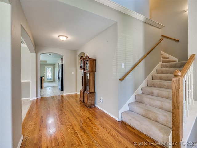 4708 W Indianola St, Broken Arrow, OK 74012 - foyer entrance with arched walkways, wood finished floors, stairway, and baseboards