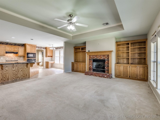 4708 W Indianola St, Broken Arrow, OK 74012 - unfurnished living room featuring a brick fireplace, light colored carpet, a ceiling fan, ornamental molding, and baseboards