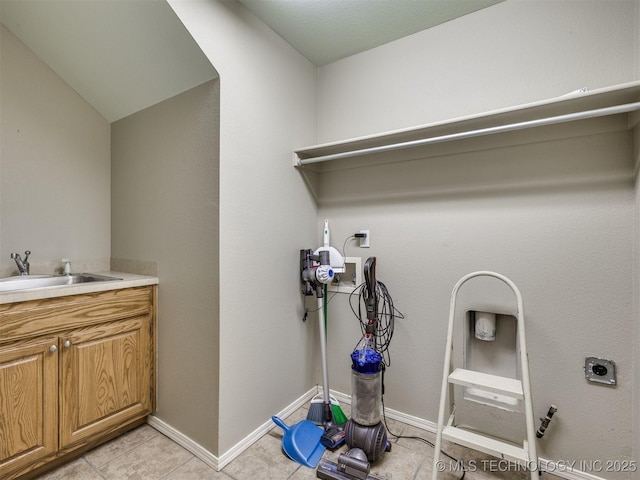 4708 W Indianola St, Broken Arrow, OK 74012 - laundry area featuring electric dryer hookup, a sink, washer hookup, light tile patterned flooring, and baseboards