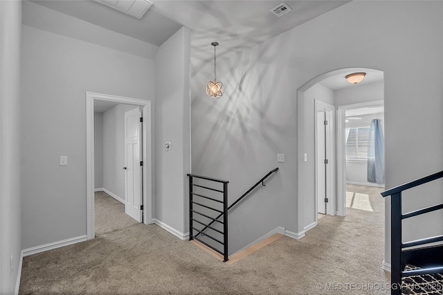 4922 S 81st W Ave, Tulsa, OK 74107 - hallway with an upstairs landing, arched walkways, carpet, and baseboards