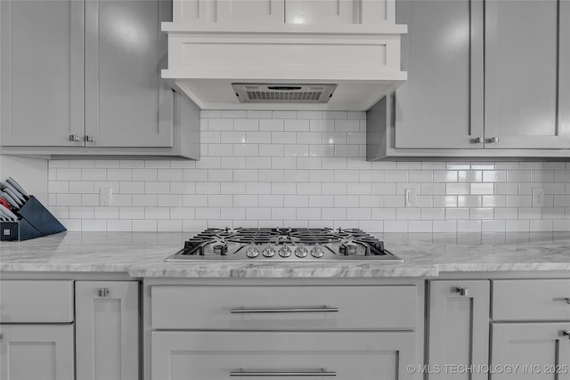 4922 S 81st W Ave, Tulsa, OK 74107 - kitchen with stainless steel gas stovetop, tasteful backsplash, and premium range hood
