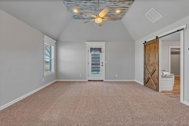 4922 S 81st W Ave, Tulsa, OK 74107 - unfurnished bedroom with a barn door, carpet, vaulted ceiling, baseboards, and ceiling fan