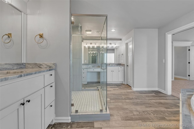 4922 S 81st W Ave, Tulsa, OK 74107 - bathroom with vanity, wood finished floors, baseboards, a stall shower, and recessed lighting