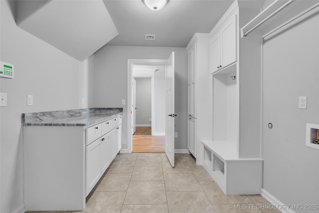 4922 S 81st W Ave, Tulsa, OK 74107 - laundry room with washer hookup, cabinet space, baseboards, and light tile patterned floors