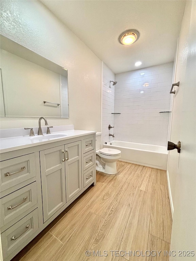 1903 Swan Ln, Mcalester, OK 74501 - bathroom with wood finished floors, toilet, vanity, and  shower combination