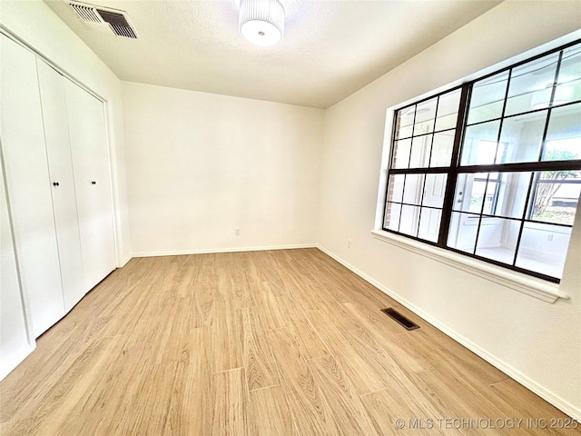 1903 Swan Ln, Mcalester, OK 74501 - unfurnished bedroom featuring wood finished floors, baseboards, and a closet