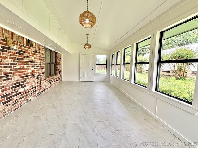 1903 Swan Ln, Mcalester, OK 74501 - unfurnished sunroom with brick wall, marble finish floors, baseboards, and vaulted ceiling