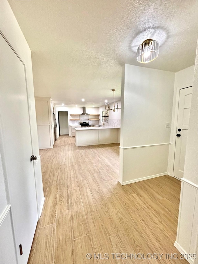 1903 Swan Ln, Mcalester, OK 74501 - hallway featuring light wood finished floors and a textured ceiling