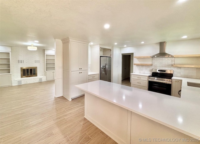 1903 Swan Ln, Mcalester, OK 74501 - kitchen with stainless steel appliances, wall chimney range hood, open shelves, light countertops, and backsplash