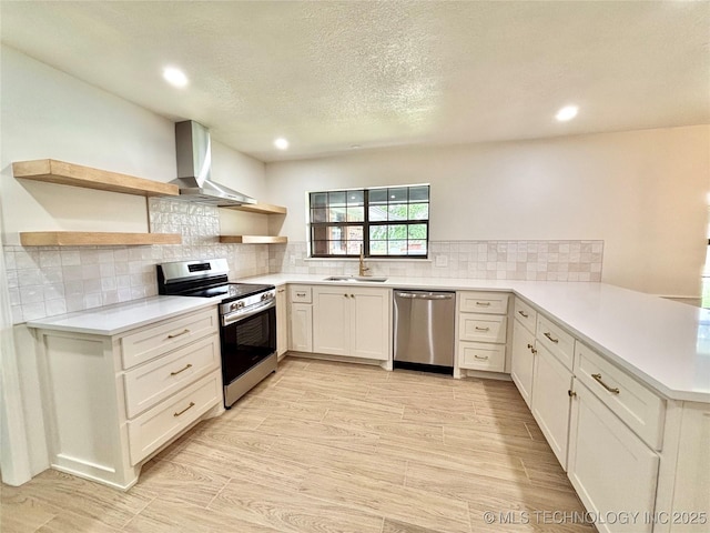 1903 Swan Ln, Mcalester, OK 74501 - kitchen featuring appliances with stainless steel finishes, wall chimney range hood, open shelves, a peninsula, and a sink
