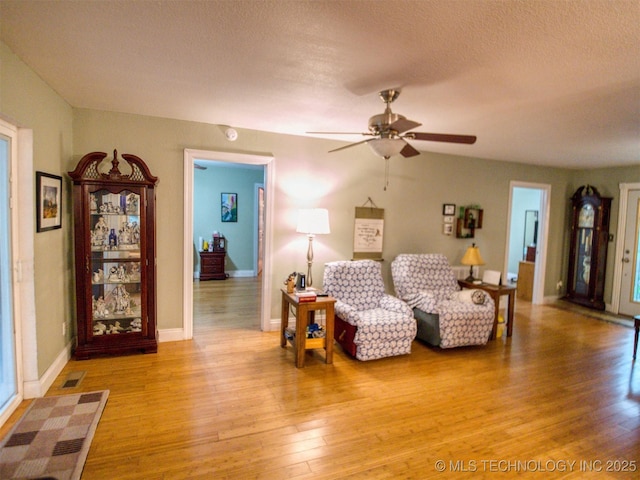5404 Ranch Rd, Kingston, OK 73439 - living room with ceiling fan, light wood-type flooring, a textured ceiling, and baseboards
