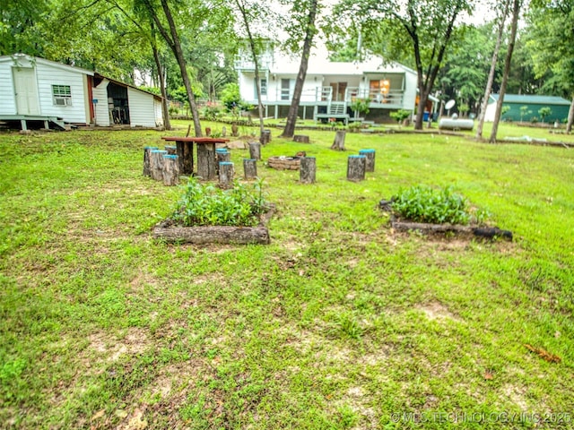 5404 Ranch Rd, Kingston, OK 73439 - view of grassy yard featuring a vegetable garden and an outdoor structure