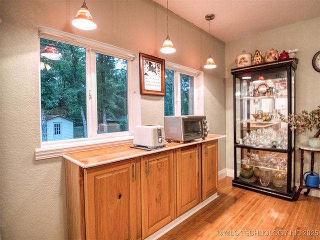 5404 Ranch Rd, Kingston, OK 73439 - kitchen featuring light wood-type flooring, decorative light fixtures, and light countertops