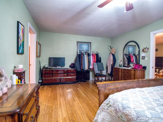 5404 Ranch Rd, Kingston, OK 73439 - bedroom with wood finished floors, ceiling fan, and a textured ceiling