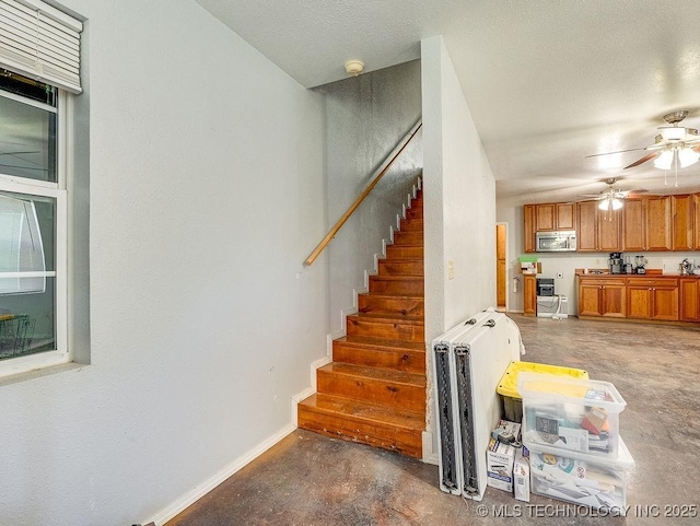 1533 County Road 3480, Ada, OK 74820 - stairs with concrete floors, a ceiling fan, and baseboards