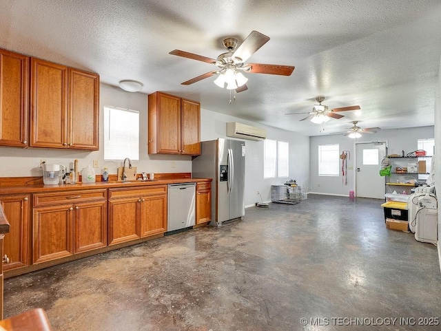 1533 County Road 3480, Ada, OK 74820 - kitchen featuring stainless steel appliances, a sink, brown cabinets, concrete floors, and a textured ceiling