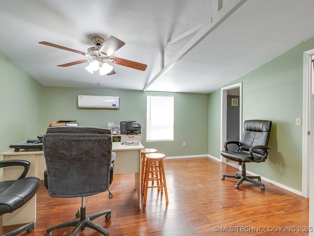 1533 County Road 3480, Ada, OK 74820 - office featuring a wall mounted AC, wood finished floors, a textured ceiling, ceiling fan, and baseboards