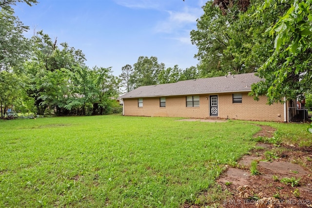 202 NE B St NE, Inola, OK 74036 - rear view of property featuring a lawn and brick siding