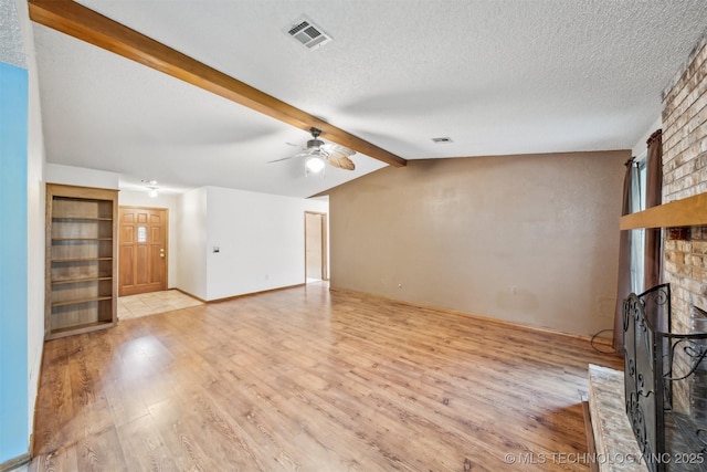 2910 S Main St, Sapulpa, OK 74066 - unfurnished living room with a brick fireplace, light wood-type flooring, ceiling fan, and a textured ceiling