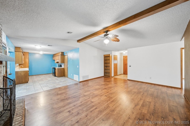 2910 S Main St, Sapulpa, OK 74066 - unfurnished living room with ceiling fan, light wood-style floors, a sink, a fireplace, and a textured ceiling