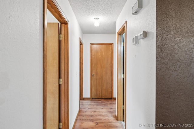 2910 S Main St, Sapulpa, OK 74066 - hall with a textured ceiling, light wood finished floors, and a textured wall