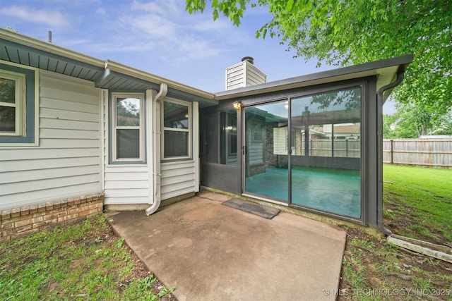 2910 S Main St, Sapulpa, OK 74066 - back of property with a patio area, a chimney, and a sunroom