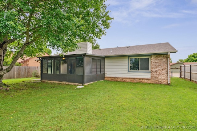 2910 S Main St, Sapulpa, OK 74066 - back of property with a sunroom, brick siding, a chimney, and a shingled roof