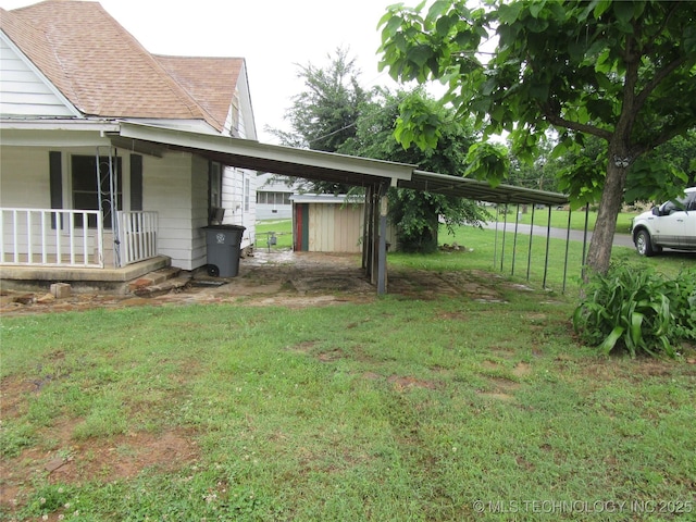 1000 N 6th, Quinton, OK 74561 - view of green lawn featuring an attached carport and a porch